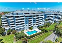 Modern condominiums featuring a sparkling pool, well maintained landscaping, and balconies with views at 1000 Riverside Dr # B202, Palmetto, FL 34221