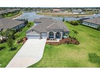 Beautiful single-Gathering home featuring a well-manicured lawn, neutral paint colors, and an attached two-car garage at 14914 15Th E St, Parrish, FL 34219