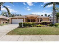Charming single Gathering home with well-manicured lawn and landscaping in front yard at 3108 River Woods Dr, Parrish, FL 34219