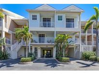 Attractive three-story townhouse with balconies and tropical landscaping at 3248 Mangrove Point Dr, Ruskin, FL 33570