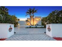 Stunning modern home featuring unique architectural elements, a circular driveway, and beautiful landscaping at 360 N Washington Dr, Sarasota, FL 34236