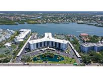 Stunning aerial view of condo community with bay access and waterfront views at 5855 Midnight Pass Rd # 512, Sarasota, FL 34242