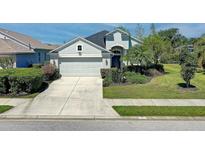 Charming single-Gathering home with well-maintained landscaping and a paved driveway leading to an attached two-car garage at 6412 Golden Eye Gln, Lakewood Ranch, FL 34202