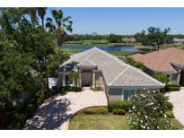 Stunning single-story home boasts lush landscaping, a paver driveway, and golf course views at 8715 52Nd E Ave, Bradenton, FL 34211