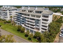 Modern condo building features balconies with nice views of green trees and well-maintained lawn at 1000 Riverside Dr # B501, Palmetto, FL 34221