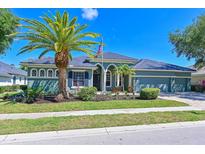Charming single-story home with a well-manicured lawn, beautiful landscaping, and an inviting front porch at 10411 Winding Stream Way, Bradenton, FL 34212