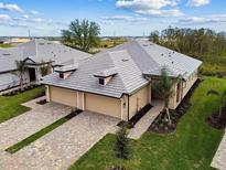 Beautiful house featuring a brick driveway, well-manicured lawn, and a two-car garage at 18016 Cherished Loop, Bradenton, FL 34211