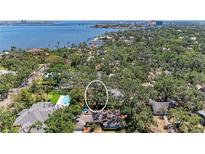 Expansive aerial view of the home with mature trees and a glimpse of the waterfront at 209 29Th Nw St, Bradenton, FL 34205