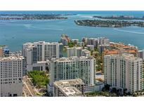 Stunning aerial view of a city skyline and waterfront featuring multiple high-rise condominium buildings and waterways at 301 Quay Commons # 611, Sarasota, FL 34236