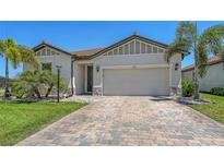 Charming single-story home features a two-car garage, tiled roof, and well-manicured landscaping at 3803 Savanna Palms Ct, Bradenton, FL 34211