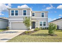 Charming two-story home with a well-manicured lawn and a two-car garage at 3813 Lively Coral Pl, Bradenton, FL 34208