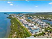 Stunning aerial view of a community with waterfront condos, green spaces, and access to beautiful water views at 388 Aruba Cir # 103, Bradenton, FL 34209