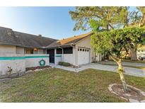 Inviting single-story home features a well-manicured lawn and an attached single-car garage at 428 40Th W Ct, Palmetto, FL 34221