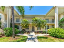 Charming condo featuring tropical landscaping, bright exterior, and welcoming walkway at 4640 Tower Hill Ln # 2325, Sarasota, FL 34238