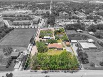 Aerial view of the property with mature landscaping and a pond at 5024 37Th E St, Bradenton, FL 34203