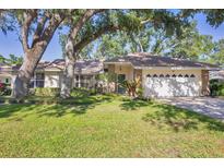 Charming single-story home with a well-manicured lawn and mature trees offering plenty of shade at 5711 Garden Lakes Fern, Bradenton, FL 34203