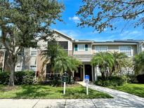 Inviting two-story home with lush landscaping, palm trees, and a clearly marked address at 7411 Vista Way # 102, Bradenton, FL 34202