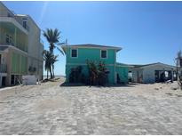 Turquoise two-story home near the beach with a brick parking area at 1190 Shore View Dr # C, Englewood, FL 34223
