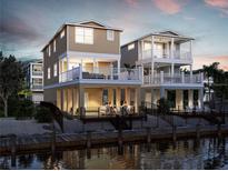 Stunning waterfront home featuring a private pool and balconies overlooking the water at 12415 Dockside Ter, Cortez, FL 34215