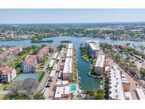 Beautiful aerial view of a waterfront condo community with boat docks and picturesque bay views at 1250 N Portofino Dr # 304, Sarasota, FL 34242
