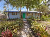 Charming home with a lush landscaped yard and a stone walkway leading to the front door at 1350 40Th St, Sarasota, FL 34234