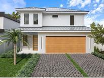 Modern two-story home features a stylish garage, sleek driveway, and well-maintained landscaping at 2483 Bay St, Sarasota, FL 34237