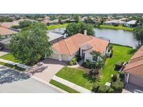 Beautiful single Gathering home with a terracotta roof and large two car garage, set by a pond at 2931 Bravura Lake Dr, Sarasota, FL 34240