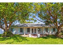 Charming single-story home featuring lush landscaping and double-door entry at 2961 Valencia Rd, Venice, FL 34293