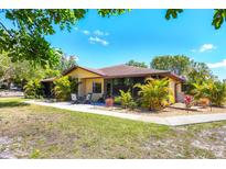 Charming single-story home with a well-maintained lawn, mature landscaping, and a cozy screened-in patio area at 4169 66Th Street W Cir # 4169, Bradenton, FL 34209