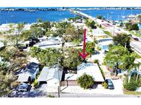 Charming waterfront cottage with mature trees, offering convenient access to the bridge and a serene coastal living experience at 4408 125Th W St, Cortez, FL 34215