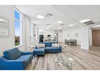 Spacious living room with modern decor, large windows, and an open floor plan leading to the kitchen at 516 Tamiami S Trl # 102, Nokomis, FL 34275