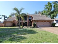 Charming two-story home with a well-manicured lawn, mature landscaping, and a spacious driveway at 5340 Dominica Cir, Sarasota, FL 34233