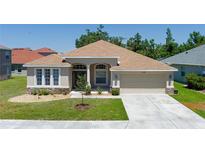 Charming single-story home with a well-manicured lawn and two-car garage, showcasing its inviting curb appeal at 6106 34Th E Ct, Ellenton, FL 34222