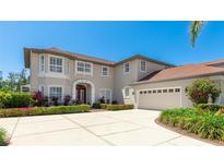 Elegant two-story home with a well-manicured lawn, beautiful landscaping, and a spacious three-car garage at 9226 13Th Avenue Nw Cir, Bradenton, FL 34209