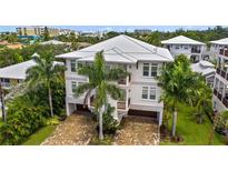 Gorgeous three story home with beautiful stone paver driveway and lush tropical landscaping at 1021 Crescent St # 1, Sarasota, FL 34242