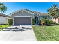 Charming single-story home with a well-manicured lawn and attached two-car garage at 10806 52Nd E Ct, Parrish, FL 34219