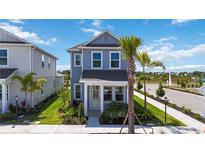 Charming two-story home featuring a well-manicured lawn, lush landscaping, and a welcoming entrance at 160 Eagleston Ln, Lakewood Ranch, FL 34240