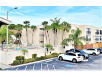 Relaxing condo community featuring a pool, palm trees and convenient parking at 2763 Woodgate Ln # 108, Sarasota, FL 34231