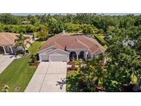 Sprawling single-story home with a well-manicured lawn, mature trees and beautiful landscaping at 3816 Little Country Rd, Parrish, FL 34219