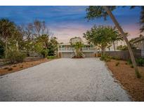 Charming two-story home features a spacious driveway and a welcoming front porch at 4818 Givens Ct, Sarasota, FL 34242