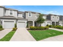 Charming townhouse with a one-car garage, well-maintained lawn, and landscaped garden at 8596 Lunar Skye St, Sarasota, FL 34241
