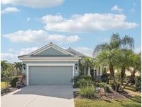 Charming single-story home featuring a well-manicured front yard and an attached two-car garage at 12676 Sagewood Dr, Venice, FL 34293