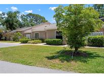Charming single-story home featuring a well-manicured lawn and mature trees at 3360 Tallywood Ct # 7082, Sarasota, FL 34237