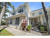 Charming two-story home featuring a well-manicured lawn and tropical landscaping, with a welcoming front entrance at 3405 54Th W Dr # 102, Bradenton, FL 34210