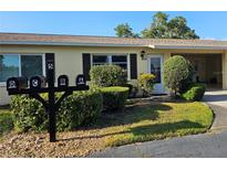 Charming villa exterior with manicured landscaping, multiple mailboxes, and well-maintained facade at 390 301 W Blvd # 5B, Bradenton, FL 34205