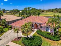 Stunning single-story home boasts tile roof, lush landscaping, and desirable golf course views at 407 Fieldstone Dr, Venice, FL 34292