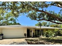 Charming single-story home with mature trees, a two-car garage, and a well-maintained front yard at 4170 Prudence Dr, Sarasota, FL 34235