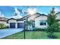 Beautiful single-Gathering home with well-manicured lawn, pavers, and attached two-car garage at 4970 Oyster Pearl St, Lakewood Ranch, FL 34211