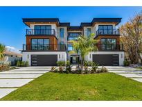 Stunning modern home featuring multi-level balconies, a stone facade, and a well-manicured front lawn at 540 S Polk Dr, Sarasota, FL 34236
