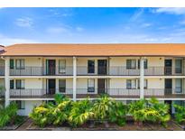 Exterior view of condo building with multiple units, balconies, and lush landscaping on a bright day at 7203 Curtiss Ave # 3D, Sarasota, FL 34231